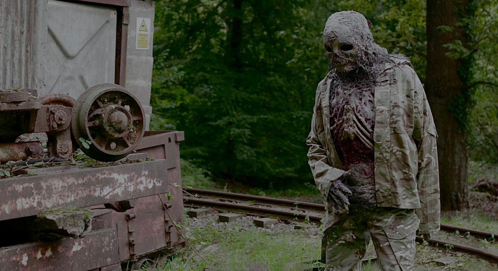 A shot from test footage taken of a zombie shambling near a disused railway