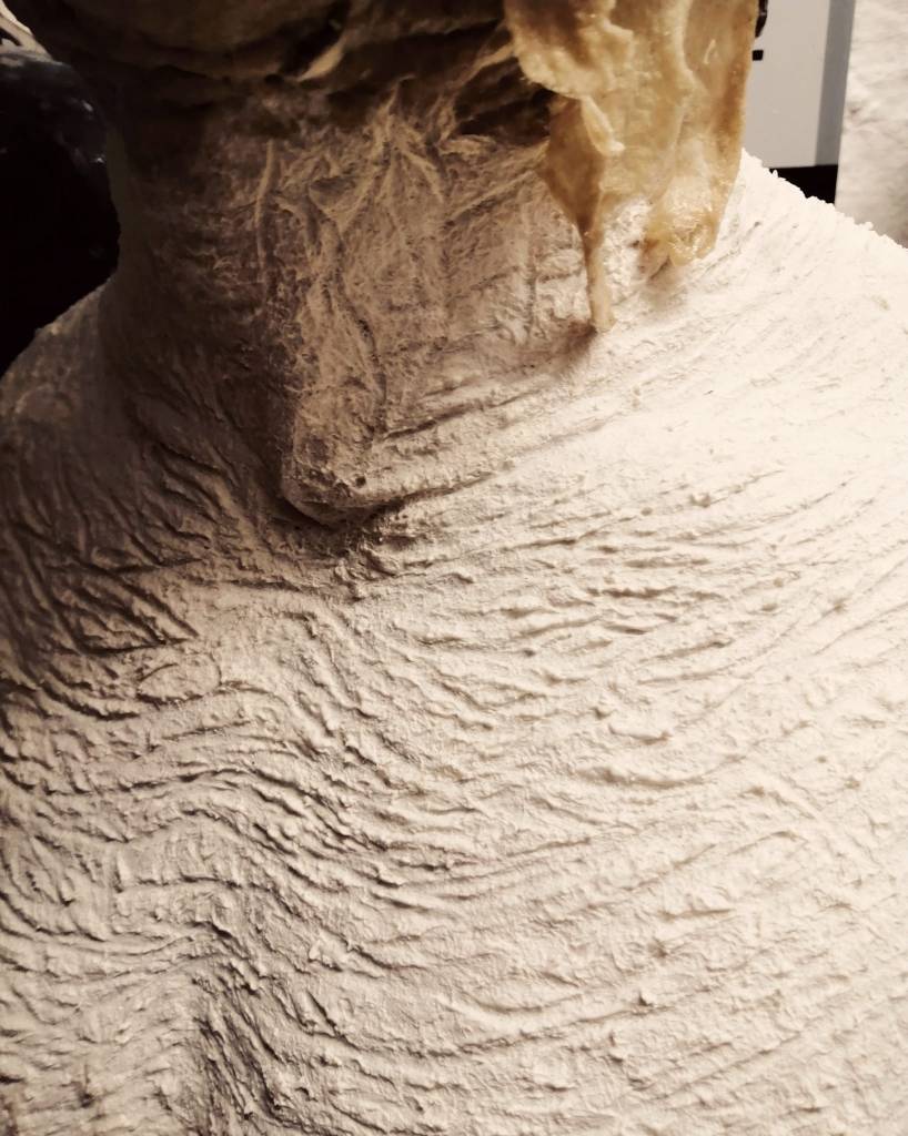 Skin texture is sculpted into the cotton batting before it completely dries...