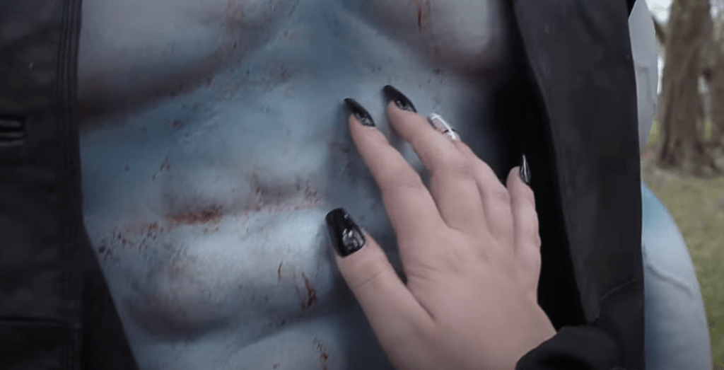 One of the characters strokes Graveyard Shark's abs...