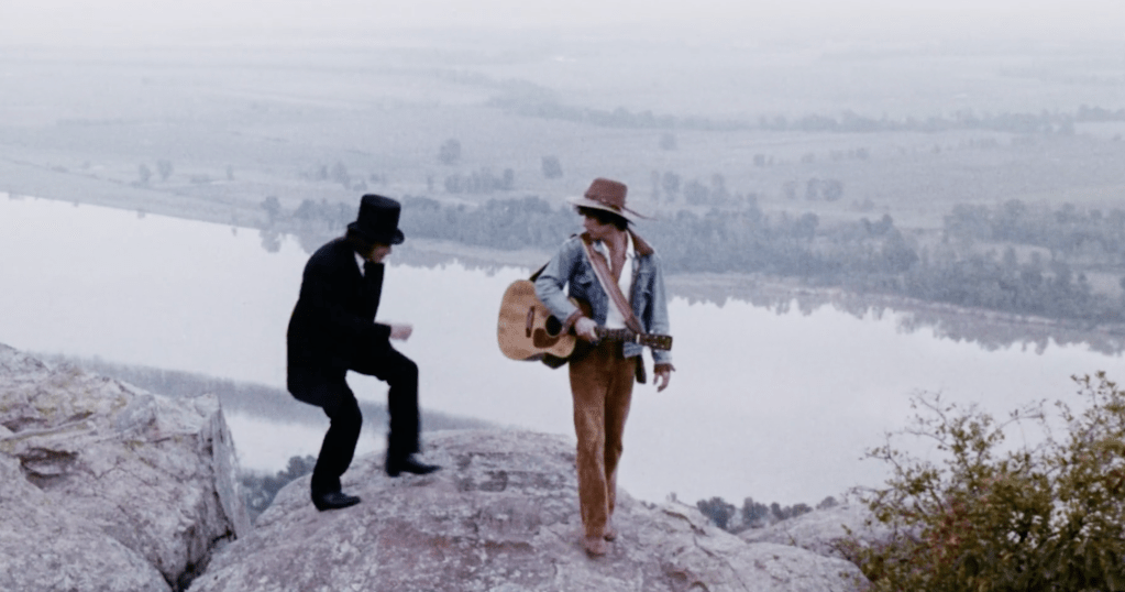 John and Yandro climb up the mountain