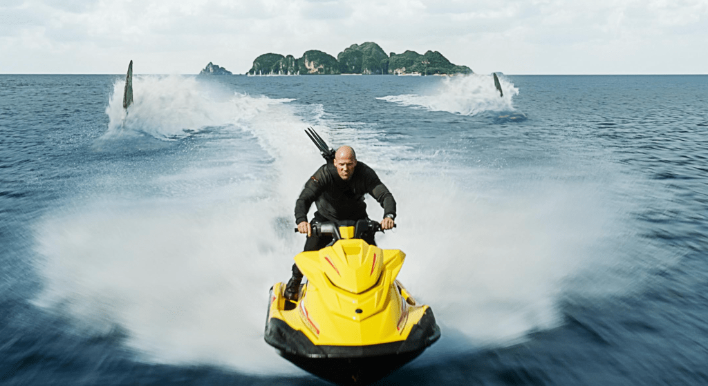Statham on a jet ski, chased by monster sharks!