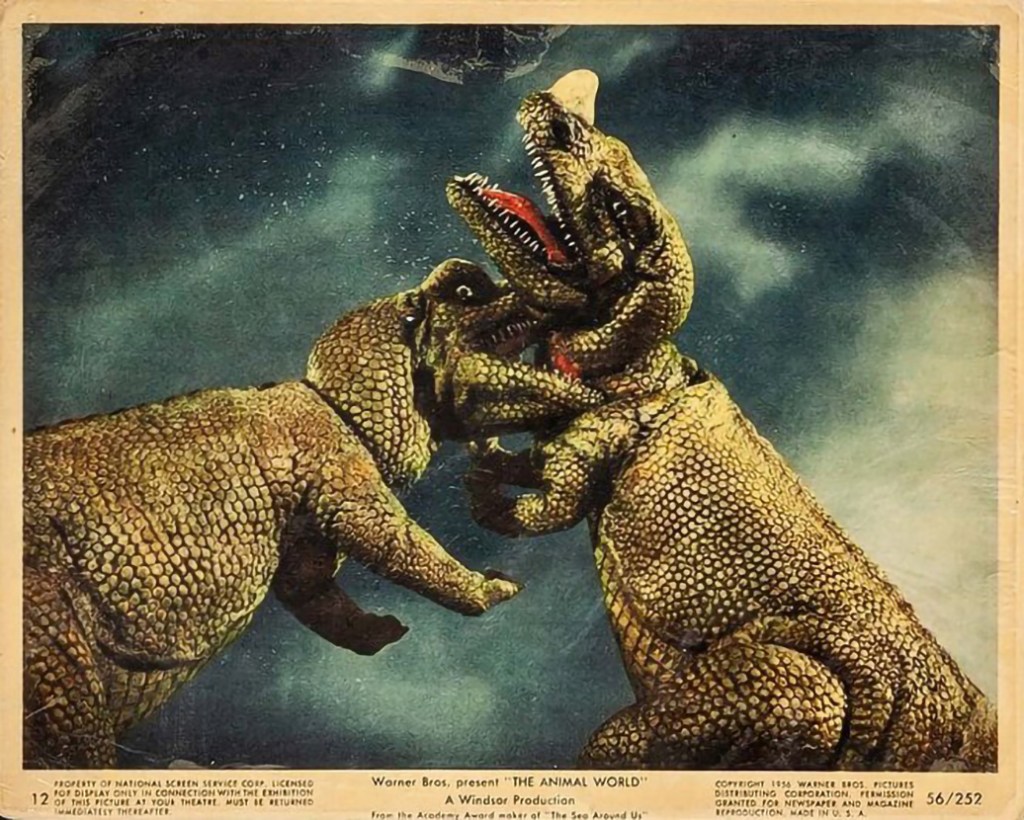 Lobby card for THE ANIMAL WORLD, showing two of the mechanical dinosaur models
