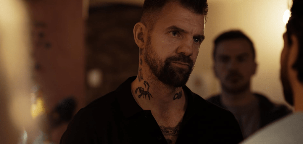 Tattooed local Ruskin (Marco Antonio Clifton) is far from friendly when Olivia and her friends visit the nearby pub