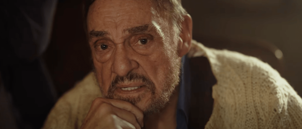 Professor Harisson (John Rhys-Davies) attempts to dissuade the group of friends from exploring the cave system