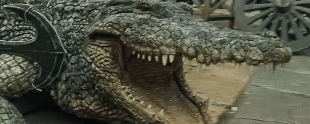 Qi manages to snag the great reptile by hooking an anchor into its shoulder!