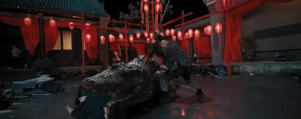 Qi stabs the croc with a spear!