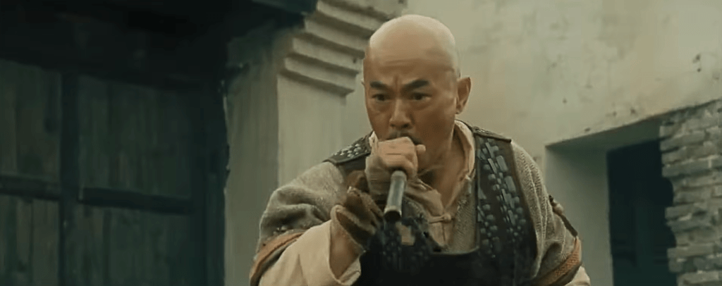 Qi, played by Hung Yan-Yan (ONCE UPON A TIME IN CHINA III), uses a blowpipe to fire a dart at the croc!