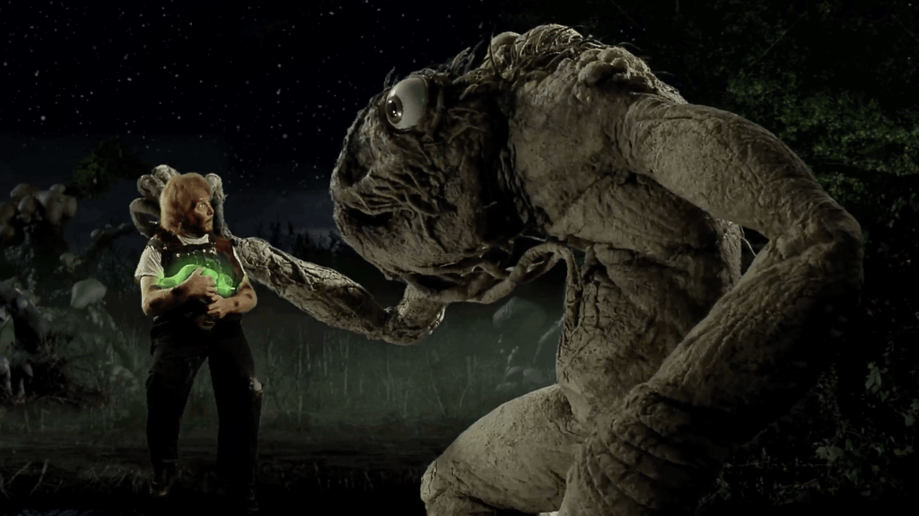 The Bart-monster lifts up his brother Mart, who holds the glowing alien gizmo
