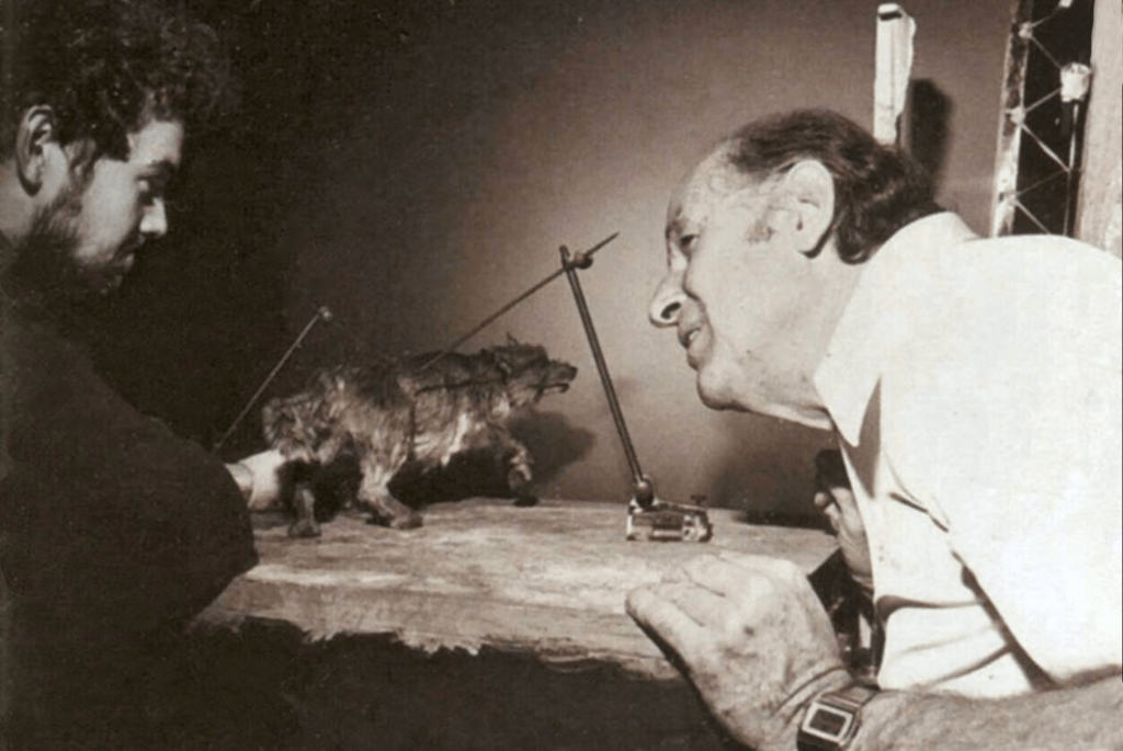 A photo of Steve and Ray with the stop-motion puppet of the 2-headed dog/wolf creature Dioskilos